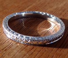 "This wedding band is made of in platinum. The Band is hand miligrained, engraved and high polished. This Art deco style band is 2 mm wide, 1.75 mm tall and available in all finger sizes. This band is made to order and is a FINAL SALE NO RETURNS We love this ring because it represents the way jewelry should be made with craftsmanship and quality. This ring is anything but ordinary. Our pieces are designed and made with craftsmanship and sustainability in mind, our designs are made with handpicke Heirloom Etched Wedding Jewelry, Heirloom Etched Jewelry For Wedding, Heirloom Etched Wedding Bands, Fine Jewelry Engraved Ring For Wedding, Heirloom Etched Jewelry For Marriage, Formal Engraved Ring With Decorative Band, Classic Platinum Bands For Gifts, Classic Platinum Bands Perfect For Gifts, Heirloom Engraved Ring With Diamond Cut In Round Band