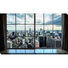 an empty room with large windows looking out on the cityscape and skyscrapers