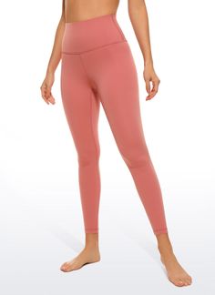 a woman in pink leggings with her hands on her hips and one hand on her hip