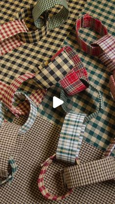 several different colored ties laid out on top of a tablecloth covered with checkered fabric