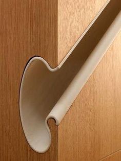 a close up of a door handle on a wooden door with wood grained background