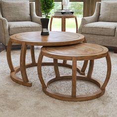 three wooden tables sitting on top of a carpeted floor next to two couches