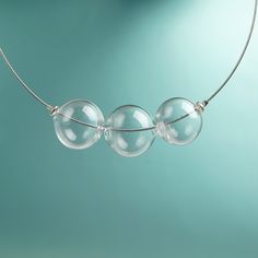 "This Clear glass ball necklace is made of glass in the lampwork technique, each bead is hand blown and unique. This bold chunky necklace is lightweight, stylish and elegant and will become a versatile and irreplaceable addition to your everyday outfits! 💕 You will definitely look stunning in this glass bubble necklace! Dimensions: the necklace length is not adjustable and is 17 3/4\" inch (45 cm). Materials: artist lampwork glass beads, metal fittings. 🎁 This big bead necklace will also be a Modern Handmade Clear Necklaces, Clear Glass Beaded Necklaces, Clear Glass Round Bead Necklaces, Clear Glass Round Beads Necklaces, Clear Glass Necklaces With Round Beads, Round Glass Necklaces For Parties, Clear Glass Necklace For Jewelry Making, Clear Glass Necklaces For Jewelry Making, Modern Glass Necklaces With Round Beads