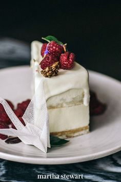 a piece of cake on a plate with raspberries