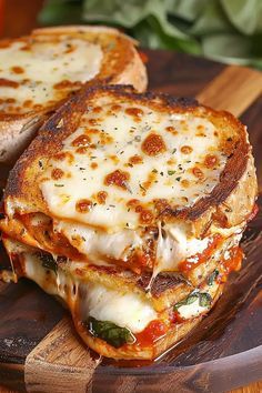 two slices of pizza sitting on top of a wooden cutting board next to a slice of bread