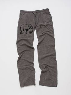 an elephant drawn on the side of a pair of sweatpants that are grey and black