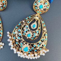 Design inspired from the Edwardian Era, these handcrafted jadau earrings have been made in sterling silver with 22K gold plating and embellished with freshwater pearls and turquoises. The earrings have a clip at the back and a threaded screw. Weight : 50 GMs, Height : 10 cm, Width : 5.5 cm Jadau Earrings, 22k Gold Jewelry Necklaces, The Edwardian Era, 22k Gold Jewelry, Pearl Necklace Set, Gold Jewelry Necklace, Emerald Necklace, Gold Bangle Bracelet, Edwardian Era