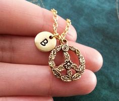 "This listing is for a personalized peace sign keychain with a hand-stamped initial charm. We can also make this into a necklace instead, just choose your chain length from the drop-down menu. You will be able to choose between a key ring, link chain, bangle bracelet, or ball chain when checking out. You will also be able to choose your initial! :) ** Please see the second picture for scale. These are SMALL charms. This keychain is made of steel and gold-colored pewter. The initial charm measure Peace Sign Jewelry, Peace Sign Necklace, Sign Necklace, Hippie Necklace, Small Charms, Personalized Keychain, Initial Charm, Peace Sign, Ball Chain