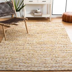 a living room area with a chair and rug