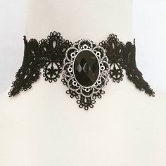 A black or purple faceted cabochon gem in a silver metal oval frame made of corrosion and tarnish resistant zinc alloy which is also a removable brooch!   Oval frame measures 4 x 3.5 cm (approx)  Gem is  2.5 x 1.8 cm (approx) Circumference is adjustable from 30 to 35 cm (approx) Width of choker is 5.5cm at widest point. Gothic Jewelry For Halloween Costume, Gothic Costume Jewelry For Halloween, Gothic Halloween Costume Jewelry, Punk Style Costume Jewelry Choker, Punk Costume Choker Jewelry, Punk Style Costume Choker Jewelry, Gothic Costume Jewelry Choker, Victorian Silver Costume Jewelry, Silver Punk Jewelry For Costume