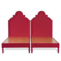 a pair of red beds sitting next to each other