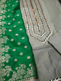 Item Overview ATHARVA Hand Embroidery Salwar Kameez w/Embroidered Neck Grey/Banarsi Silk Dupatta Green/Tunic Pants/Patiala Salwar/Churridar/Custom Stitch/ Dno. CH1455 Fabric: * Shirt Chanderi 2.5 Mts, Grey - Embroidered Neck * Dupatta: Banarsi Silk Dupatta 2.5 Mts. (Motifs May Wary) * Bottom Santoon Silk 2.5 Mts. Excusive Hand Embroidered Party Wear Punjabi Suit. Customization: * Fabrics Customization: Designs Can be made in different Fabrics. *Color Customization: Designs can be made in any col Designer Pista Green Kurta For Navratri, Festival Pista Green Cotton Silk Anarkali Set, Festive Dola Silk Kurta With Chikankari Embroidery, Pista Green Raw Silk Straight Kurta, Pista Green Raw Silk Churidar With Traditional Drape, Pista Green Anarkali Kurta For Festive Occasions, Festive Pista Green Anarkali Kurta, Designer Chanderi Churidar For Transitional Seasons, Pista Green Raw Silk Kurta For Transitional Season