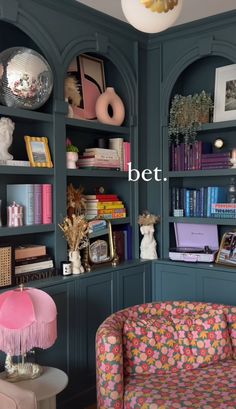 a living room filled with lots of bookshelves covered in colorful furniture and decor