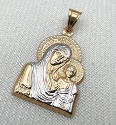 Religione offers a large selection of fine religious jewelry. Every piece of our collection is designed and crafted by talented craftsmen located in the Holy Land using pure gold and genuine diamonds. Religione designs are meant to emphasize the eternal shine that faith in God brings us.  Specification: Gold: 14k solid gold 2.00g Pendant Size: length 1.00inch width 0.8inch Each of our Jewelry pieces: Includes jewelry certificate.  Comes in an elegant jewelry box.  Shipped globally by top carrier Engraved White Gold Spiritual Jewelry And Charms, Gold Spiritual Jewelry With Diamond Cut, Spiritual Gold Jewelry With Diamond Cut, Spiritual Gold Diamond Cut Jewelry, Luxury White Gold Crucifix Jewelry, White Gold Polished Spiritual Jewelry And Charms, Gold Spiritual Jewelry And Charms For Wedding, Luxury 14k Gold Crucifix Jewelry, Stamped 14k Gold Spiritual Jewelry And Charms