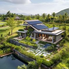 an aerial view of a house with solar panels on the roof and landscaping around it