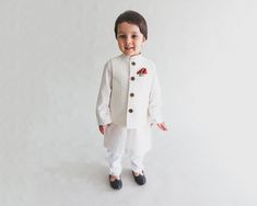 White embroidered  jacket on a fabulous white designer kurta with pajama  for your little boys.                                                                                                                                                                                                                                                                                                                                                    Cherishing the innocence of little kids, this snowy white ethnic Designer Wear Fitted White Nehru Jacket, White Fitted Nehru Jacket For Designer Wear, Off White Straight Kurta Set For Navratri, Designer Fitted White Nehru Jacket, Designer White Fitted Nehru Jacket, Off White Bollywood Sets For Transitional Season, White Cotton Nehru Jacket For Designer Wear, Designer Cotton White Nehru Jacket, Designer White Cotton Nehru Jacket