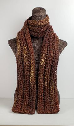 This scarf will keep you cozy and stylish in cold Winter weather. Measures 70 inches long and 5 inches wide.  Can be worn multiple ways. Made with a chunky wool blend yarn for warmth and easy care.  Machine washable. Brown Knit Scarf, Brown Winter Scarf, Casual Brown Knitted Scarf, Crochet Chunky Scarf, Brown Crochet Scarf, Brown Wool Casual Scarf, Crochet Winter Scarf, Cozy Hand Knitted Brown Scarf, Bohemian Brown Crochet Scarf