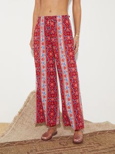 For those partial to a St Barts sojourn, the flouncy silhouettes of the Marguerite story radiates gypset chic with a cornflower motif lush with ruby hues and accented with ditsy denim blues across cotton lenzing blends. Subtle wide leg, full length pant with soft elastic waist. Featuring functional side pockets and engineered print placement to elongate the legs. Bohemian Straight Leg Pants For Vacation, Bohemian Wide-leg Floral Print Bottoms, Bohemian Rayon Pants With Floral Print, Bohemian Wide-leg Pants With Floral Print, Bohemian Boho Print Pants For Spring, Red Bohemian Bottoms For Vacation, Bohemian Wide Leg Bottoms With Floral Print, Festival Wide Leg Floral Print Bottoms, Festival Floral Print Wide Leg Bottoms