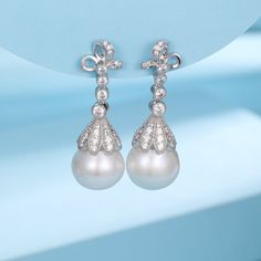 Elevate your elegance with our 12-13mm Freshwater Pearl & Vintage Bowknot Earrings, featuring exquisite zirconia accents. These sophisticated drop earrings showcase large, drop-shaped pearls with a high luster, set in silver. Each pearl is delicately adorned with a vintage bowknot design, embellished with sparkling zirconia, creating a stunning visual appeal. Perfect for those who appreciate a blend of classic charm and modern sparkle in their accessories. Product Details: Pearl Type: Freshwater Elegant Pear-shaped Pearl Earrings For Anniversary, Luxury Teardrop Pearl Earrings With Diamond Accents, Elegant Diamond Bridal Earrings With Pearl Drop, Elegant Diamond Bridal Earrings, Elegant Diamond Pear-shaped Bridal Earrings, Luxury Drop Pearl Earrings For Formal Occasions, Luxury Drop Pearl Earrings For Formal Events, Elegant Diamond Pearl Earrings, Elegant White Gold Drop Bridal Earrings