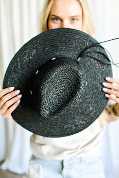 Our Bandera straw hat fits in perfectly with your spring and summer wardrobe, whether at the pool, beach or a concert! On trend w/ a western vibe, classic, chic - everything you've ever wanted in a hat. Featuring a molded crown with a pinched 10cm brim and hand woven straw, it's embellished with a faux leather and silver antique button trim. Finished off with a tassel at the back. -Rancher style hat with a chill & casual vibe-Brim is flexible but holds its shape-Coordinating faux leather band-Pi Black Summer Hats With Curved Brim, Black Summer Hat With Curved Brim, Black Bohemian Straw Hat For Summer, Black Adjustable Hat For Summer, Adjustable Black Straw Hat Made Of Paper Straw, Black Adjustable Summer Hat, Adjustable Black Summer Hat, Adjustable Black Hat For Summer, Trendy Black Summer Hat