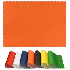 an orange place mat with different colors of paper next to it on a white background