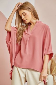 This casual oversized blouse comes with a split neckline and voluminous dolman sleeves for a relaxed but chic look. The ruffled detailing at the back gives it a little extra flair and femininity while still being easy to pair with your favorite jeans. Simply throw it on for a effortlessly stylish weekend ensemble that's perfect for coffee dates or running weekend errands. 100% Rayon Flowy V-neck Top For Work, Trendy Oversized V-neck Blouse, Chic V-neck Blouse With Relaxed Fit, Chic V-neck Tunic For Spring, Oversized Versatile V-neck Blouse, Versatile Oversized V-neck Blouse, Chic Split Neck V-neck Top For Fall, Flowy Solid Color Tops, Chic Flowy Blouse For Brunch