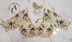 Material: Tissue.
Blouse Size: Can be customized as per your size.
Additional customizations are available such as neckline styles, sleeve lengths, and color choices.
For more details contact us on support@akruticollections.com or WhatsApp +91 9052550550
Price may vary depending on the fabric selection. Silk Blouse With Floral Embroidery For Reception, Luxury Embroidered Fitted Tops, Luxury Fitted Tops For Weddings, Luxury Fitted Top For Wedding, Designer Formal Tops With Floral Embroidery, Designer Embroidered Tops For Formal Occasions, Designer Floral Embroidered Tops For Formal Occasions, Elegant White Blouse Piece With Motifs, Fitted Motifs Blouse For Reception