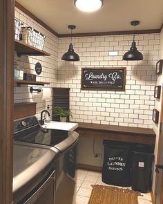 a small kitchen with white tile walls and black appliances