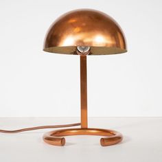 an antique brass table lamp with a dimmer on the base and a cord attached to it