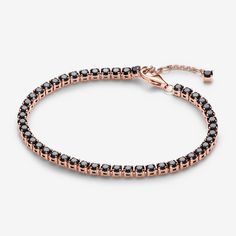 Add boldness to your look with the Black Sparkling Tennis Bracelet. Plated with 14k rose gold, it showcases 48 prong-set black man-made crystals in squared open baskets. The adjustable closure with a dangling stone offers a personalized fit. Ideal for stacking with various colours and metals, this bracelet introduces a bold black stone to Pandora's Timeless collection. Experience the elegance of repetition and contrast, adding depth to your bracelet stack. - Pandora Black Sparkling Tennis Bracelet - 14k Rose gold-plated unique metal blend / Man-made crystal / Black - Sz. 7.9 in Elegant Rose Gold Jewelry With Black Diamonds, Formal Rose Gold Jewelry With Black Diamonds, Rose Gold Jewelry With Black Diamonds, Pandora Black, Black Man, Bold Black, Black Stone, Tennis Bracelet, Lab Created Diamonds