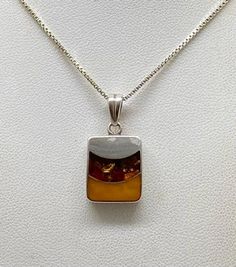 Beautiful Vintage Art Deco 925 Sterling Silver & Amber Pendant Necklace pre/owned condition chain measures 18" inches length. Yellow Polished Necklace For Anniversary, Anniversary Yellow Polished Necklace, Sterling Silver Necklace With Amber Round Pendant, Amber Necklace With Polished Finish For Anniversary, Amber Sterling Silver Pendant Necklace, Silver Rectangular Necklace With Polished Finish, Sterling Silver Necklace With Large Amber Pendant, Amber Sterling Silver Necklace With Polished Finish, Unique Sterling Silver Rectangular Necklace