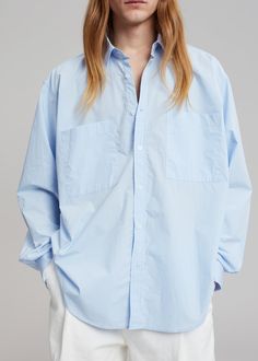 Color: Blue Crisp cotton poplin Oversized fit Pointed collar Double breast pockets Curved hem Button front closure Button cuffs 100% Cotton Dry Clean Imported One Size Product Measurements: 23" Shoulder 57" Chest 31" Length Model is 187cm/ 6'1" wearing size M Oversized Shirt, Cotton Poplin, Oversized Fits, Double Breasted, Color Blue, Dry Clean, Collar, Women's Top, How To Wear