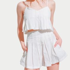 The Alaia Set is a perfect blend of elegance and versatility, designed for effortless summer style. Featuring a pleated cami and matching high-waisted shorts, this coordinated look offers both comfort and sophistication for any occasion. Summer Tops With Built-in Bra, Short Length, Chic Strapped Bottoms For Summer, Chic Bottoms With Straps For Summer, Chic Summer Bottoms With Straps, Spring Cotton Crop Top With Elastic Waistband, Chic Short Crop Top For Day Out, Cropped Summer Bottoms For Daywear, Chic Spring Crop Top With Elastic Waistband, Chic Summer Tops With Elastic Waistband