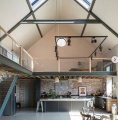 the inside of a building with an open floor plan and skylights on the roof