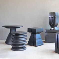 four different sized and shaped stools sitting next to each other