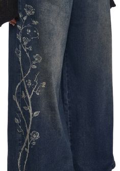 These pants have a denim construction, a wide leg silhouette, an airbrushed rose design on the sides, front and back pockets, and a front button and zipper closure. Jeans With Lace Bottoms, Cool Jeans Design, Jean Bleach Designs, Bleach Jeans Design, Bleached Jeans Design, Bleach Art Jeans, Karakuri Jeans, Cottagecore Jeans, Painted On Jeans