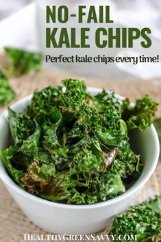 a white bowl filled with green leafy vegetables on top of a cloth covered table