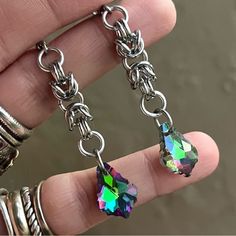 Handmade Maille & Purple Blue Green Pink Rainbow Iridescent Rainbow Austrian Crystal Dangly Earrings . Earrings Posts Are Stainless Steel . To Create The Maille Links I Use Stainless Steel Hoops As Well . It Is Nickel Free , Allergy Free , Hypoallergenic , No Itching , Do Not Change Color , Rust Or Turn Skin Green . Handmade By Me Any Questions Lmk ! Handcrafted / Boho / Bohemian / Boho Chic / Gypsie / Hippie / Festival / Goth / Gothic / Viking / Medieval / Victorian / Rock & Roll / Rocker / Roc Nickel-free Rainbow Drop Earrings, Rainbow Nickel-free Drop Earrings, Iridescent Metal Jewelry For Jewelry Making, Handmade Iridescent Metal Jewelry, Hypoallergenic Rainbow Colored Metal Jewelry, Hypoallergenic Rainbow Metal Jewelry, Rainbow Dangle Metal Earrings, Surgical Steel Dangle Single Earring, Hypoallergenic Rainbow Drop Earrings