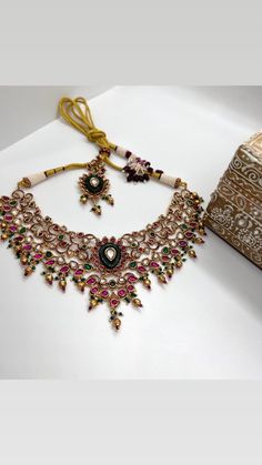 This Gorgeous Sabyasachi inspired Victorian Necklace with matching earrings. Comprises of Fine Oversized Uncut Kundan polki stones and Ruby color hangings This choker is flexible and takes the shape of the neck. Fine quality and craftsmanship. Perfect for desi weddings. Necklace comes in drawstring cord therefore adjustable Earrings length: Approx 3 inches Festive Kundan Temple Jewelry Sets, Bollywood Style Anarkali Set For Festive Occasion, Temple Jewelry Sets With Kundan And Zari Work, Intricate Design Bridal Choker For Festivals, Festival Bridal Necklace With Intricate Design Choker, Festive Kundan Sets With Tilla Details, Kundan Sets With Intricate Design For Diwali, Festive Temple Jewelry Bridal Choker Necklace, Festive Temple Jewelry Bridal Choker