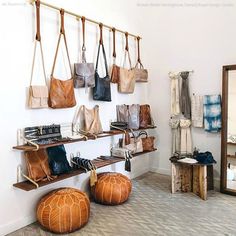 the inside of a shoe store with handbags and purses hanging from hooks on the wall