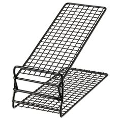 a chair that is sitting on top of a metal stand with its legs spread out