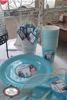 there is a table set up with plates and cups