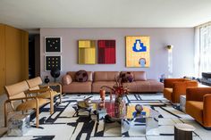 a living room filled with lots of furniture next to a wall mounted flat screen tv