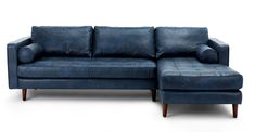 a blue leather sectional sofa sitting on top of a white floor