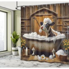 a shower curtain with a cow taking a bath in a tub full of soapy bubbles