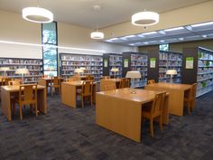 an empty library with many tables and chairs