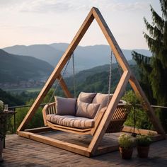 a wooden chair sitting on top of a wooden deck next to a tree filled hillside