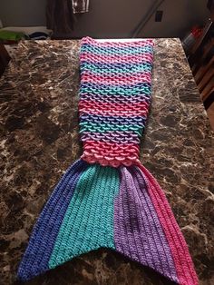 a knitted mermaid tail sitting on top of a counter