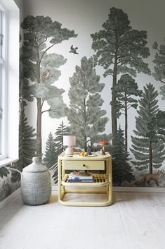 the wallpaper in this room is painted with black and white trees