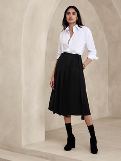 This midi skirt uses a pleated, asymmetrical front to inspire and is cut from a bonded twill fabric we love for its soft structure.  A-line fit.  Adjustable belt at wearer's left.  Side seam pockets.  Unlined.  A-line.  Midi length.  Model: Size 2, 5'10" (178cm). Midi Length Skirt With Belt Loops, Fitted Belted Pleated Skirt For Work, Relaxed Fit Belted Flared Skirt, Fall Pleated Skirt With Belt Loops For Work, Fall Workwear Pleated Skirt With Belt Loops, Asymmetrical Lined Skirt For Work, Lined Asymmetrical Skirt For Work, Relaxed Asymmetrical Skirt With Belt Loops, Midi Length Bottoms For Workwear In Fall